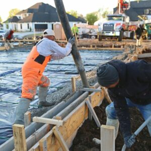 man in protective gear installing stem wall foundation