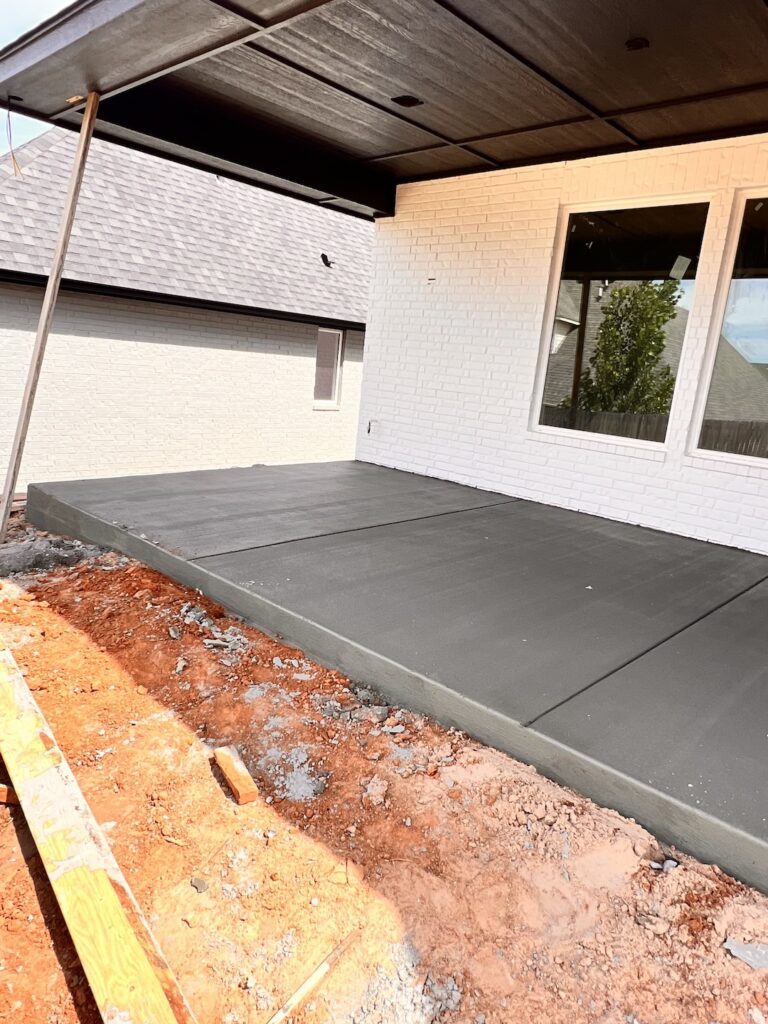 private space with a freshly poured slab of concrete for a residential home